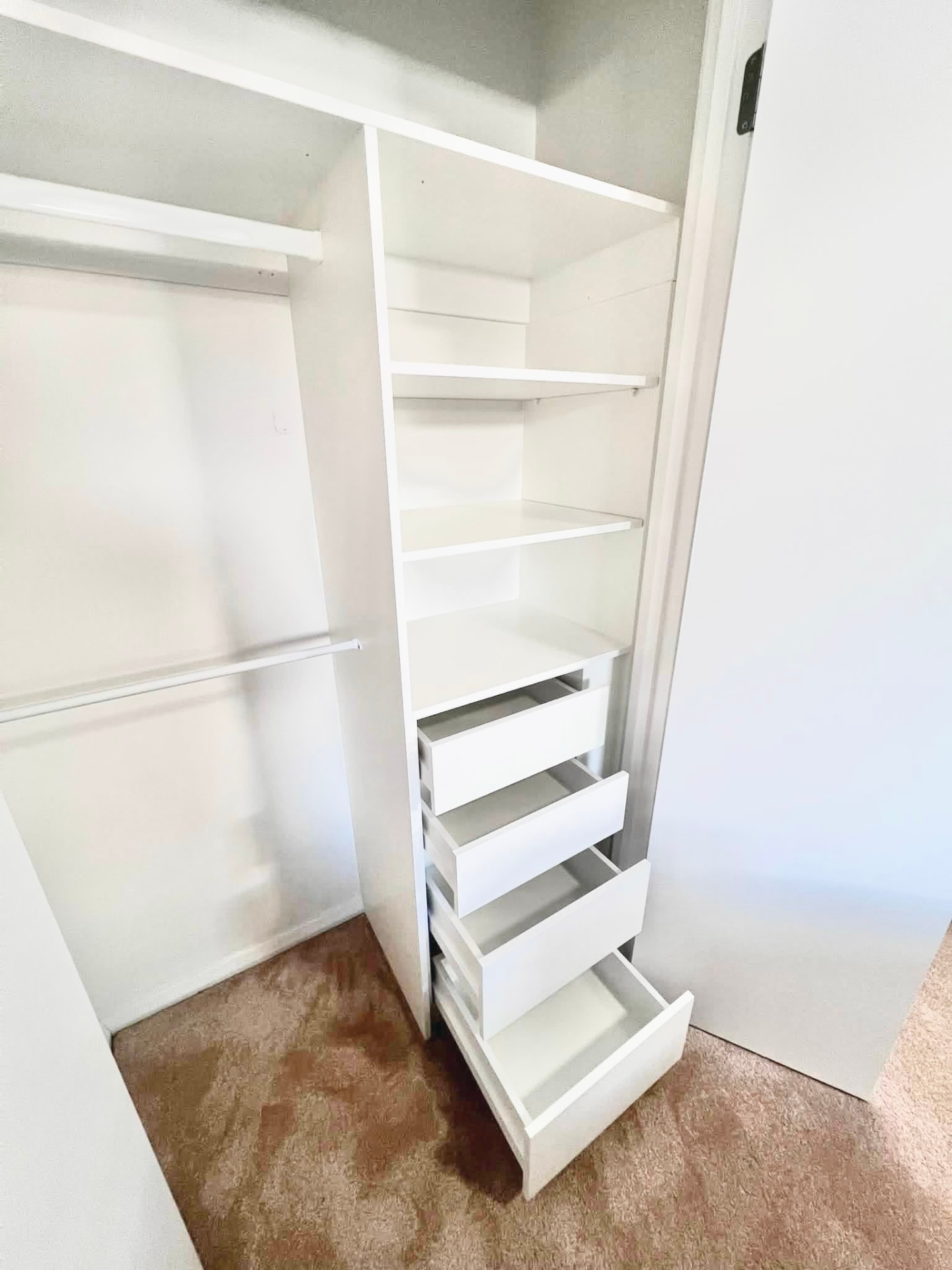 Wardrobe drawer bank and shelving unit installed in a robe